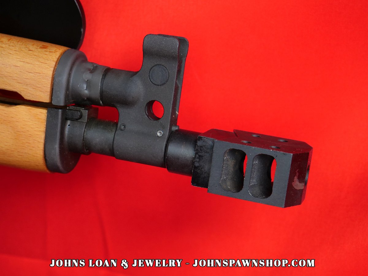 Detailed close-up focusing on the muzzle and gas block of a Century Arms VSKA Draco pistol, a semi-auto firearm at John's Loan & Jewelry; showing the dark finish and front sight post.