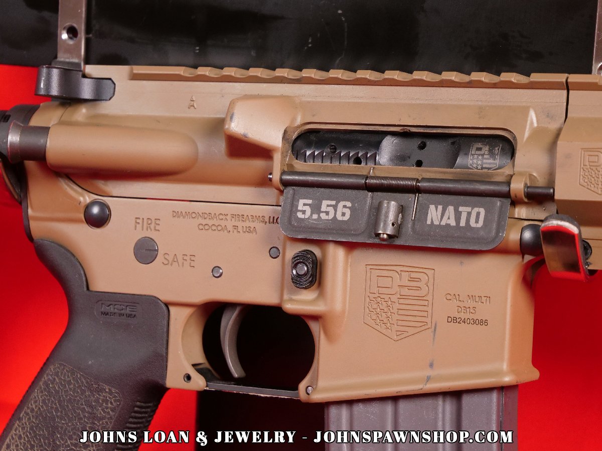 Detailed image of the Diamondback DB15 AR15 pistol receiver, chambered in 5.56 NATO, available at John's Loan & Jewelry. The firearm features an FDE finish, a Magpul pistol grip, and is designed for exceptional performance.
