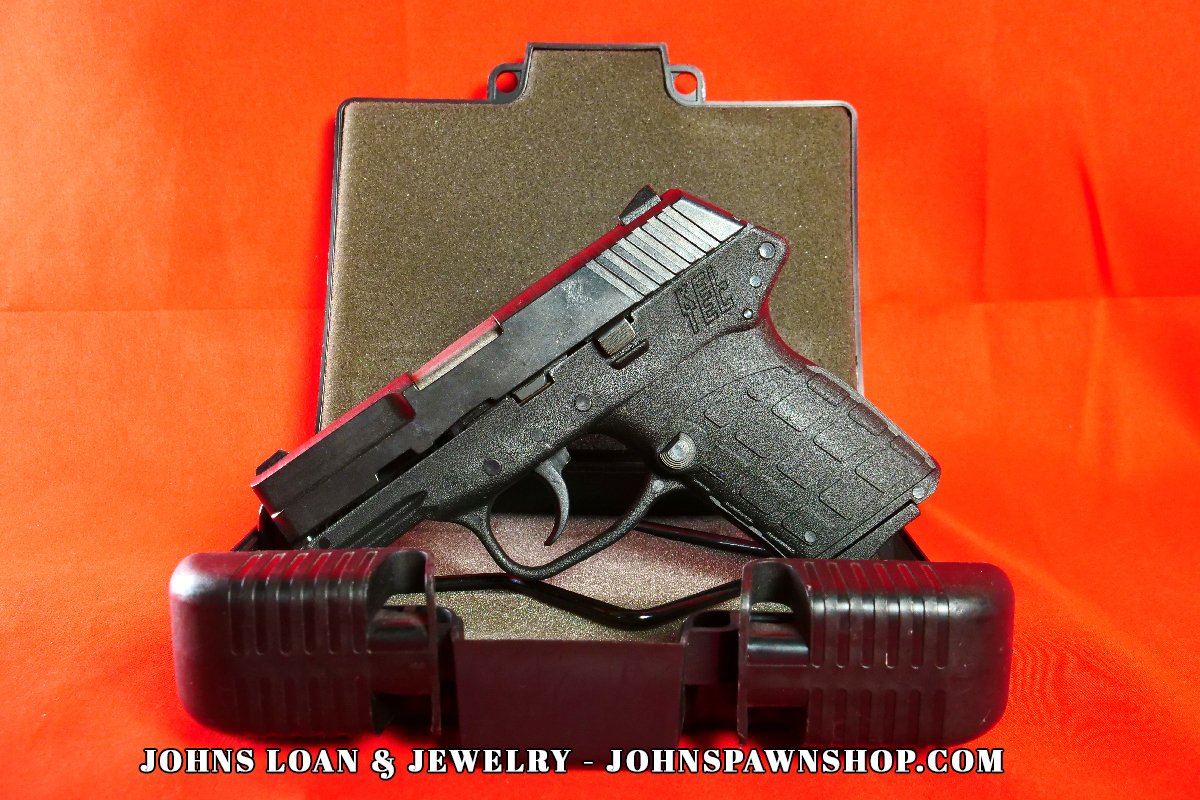 KelTec PF-9 semi-auto pistol, with the polymer frame, inside a case at John's Loan & Jewelry, a compact firearm designed for concealment and personal protection.