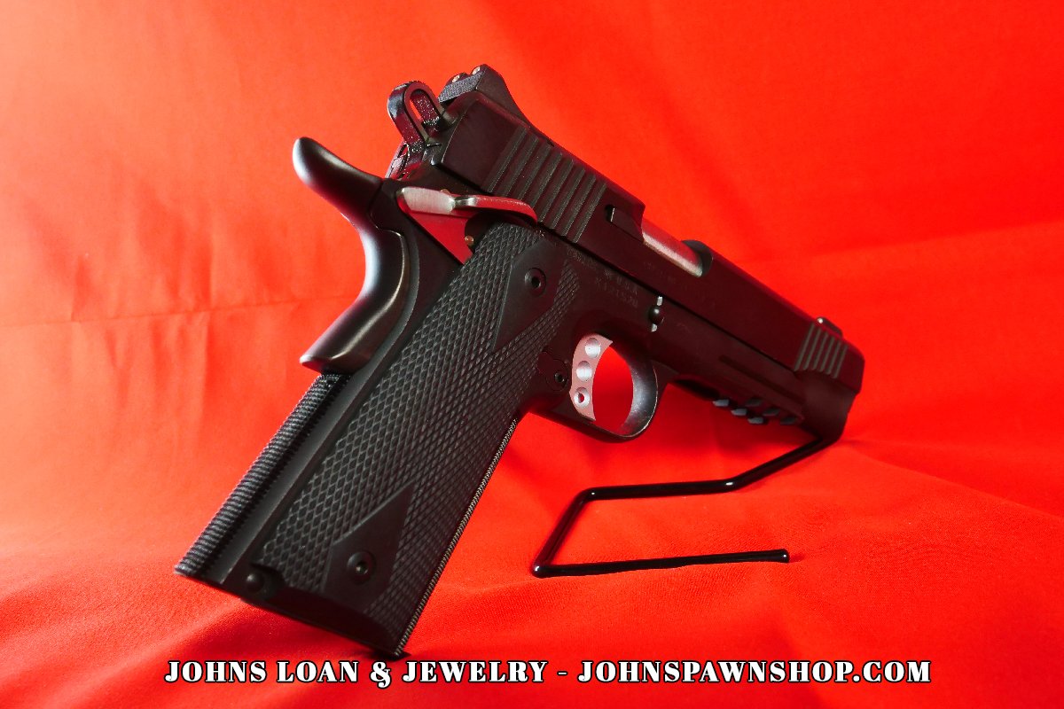 Three-quarter angle of the Kimber Custom TLE/RL II .45 ACP pistol, highlighting the accessory rail, slide serrations, and ergonomic grip, available from John's Loan & Jewelry.