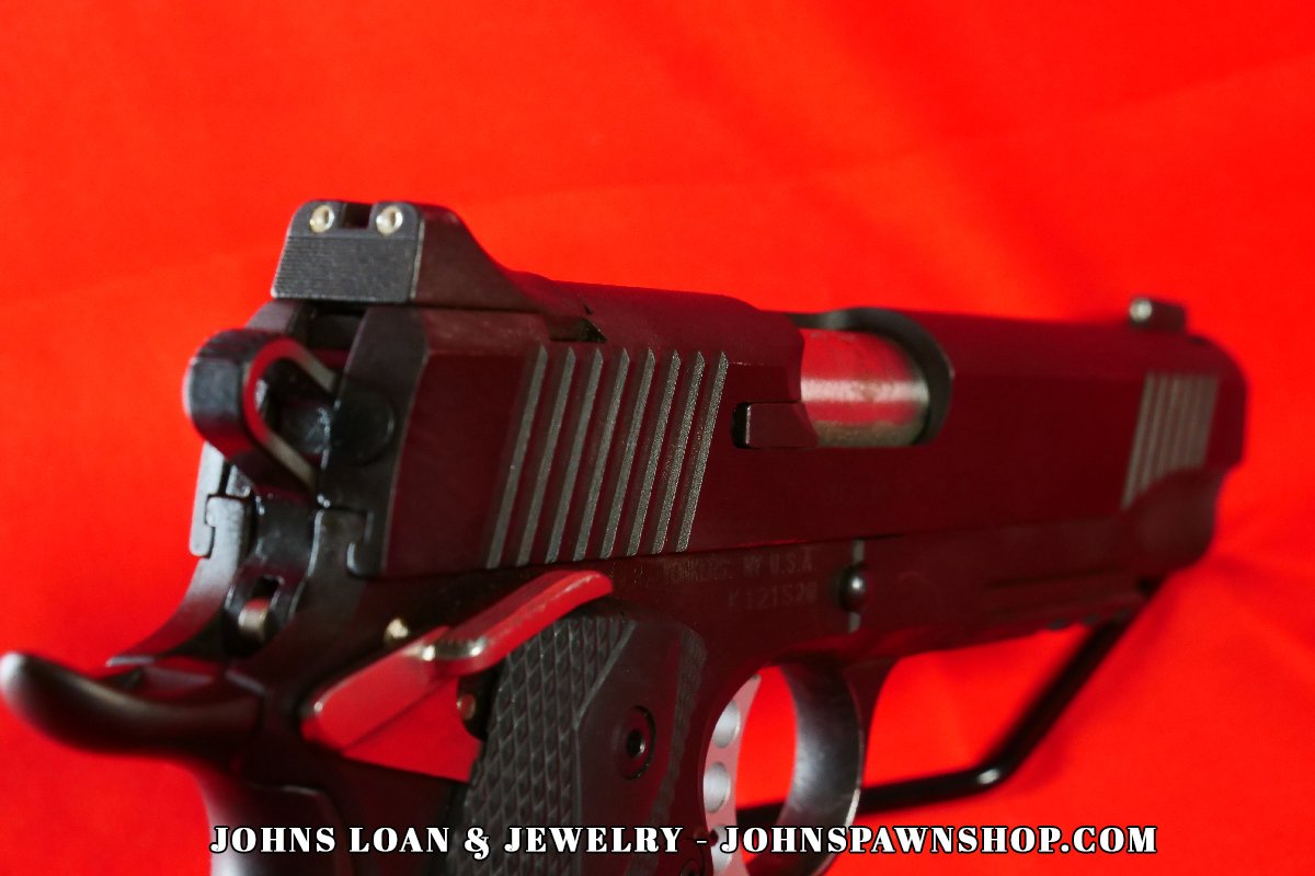 Detailed rear view of the Kimber Custom TLE/RL II pistol, showcasing the adjustable sights, slide serrations, and beavertail grip safety, offered by John's Loan & Jewelry.