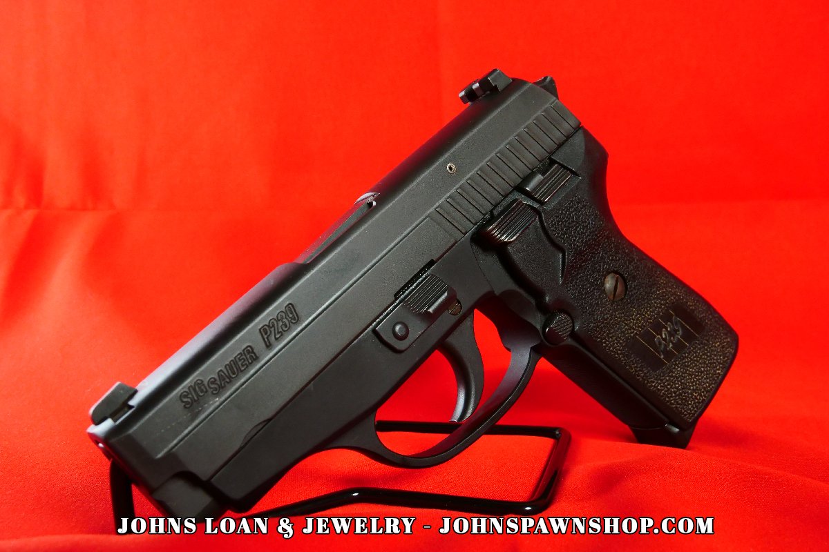 Close-up detail of the Sig Sauer P239 semi auto pistol, highlighting the slide serrations and frame, available at John's Loan & Jewelry, a Las Vegas pawn shop.