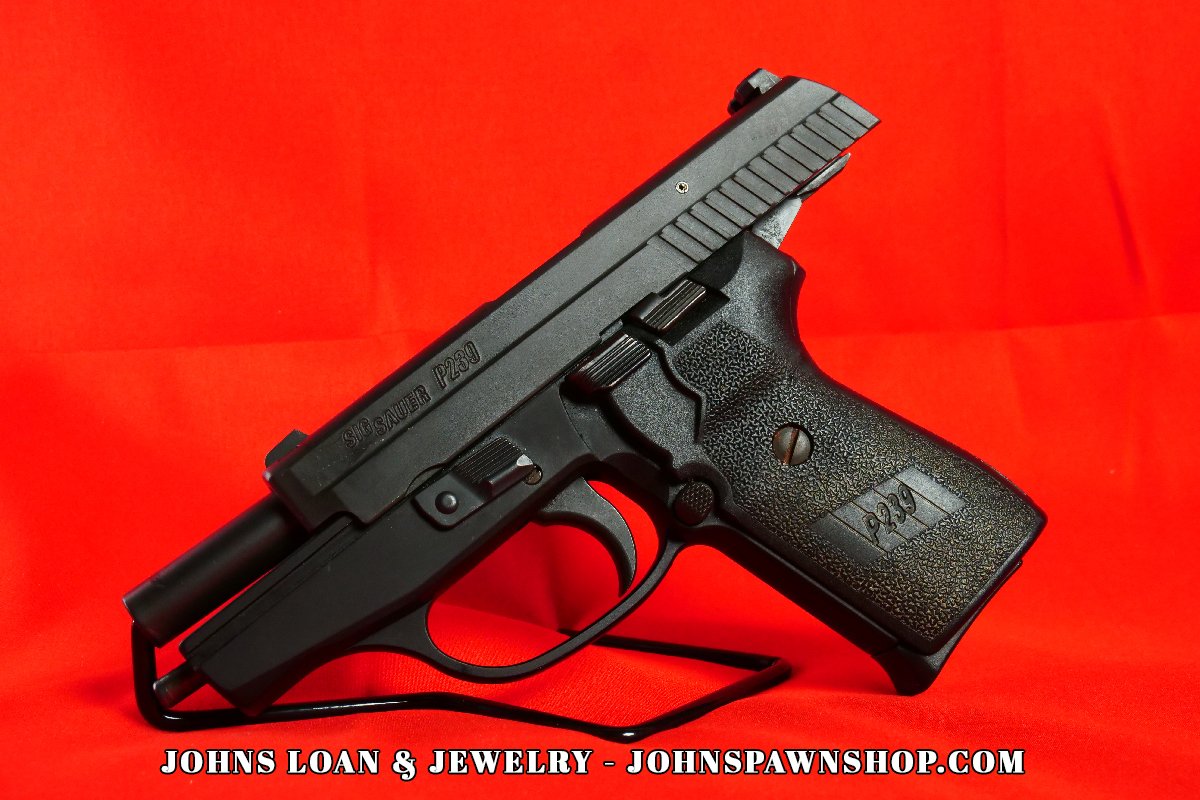 Side view of a Sig Sauer P239 9mm semi auto pistol, featuring the textured grip and slide, available at John's Loan & Jewelry, a trusted pawn shop.