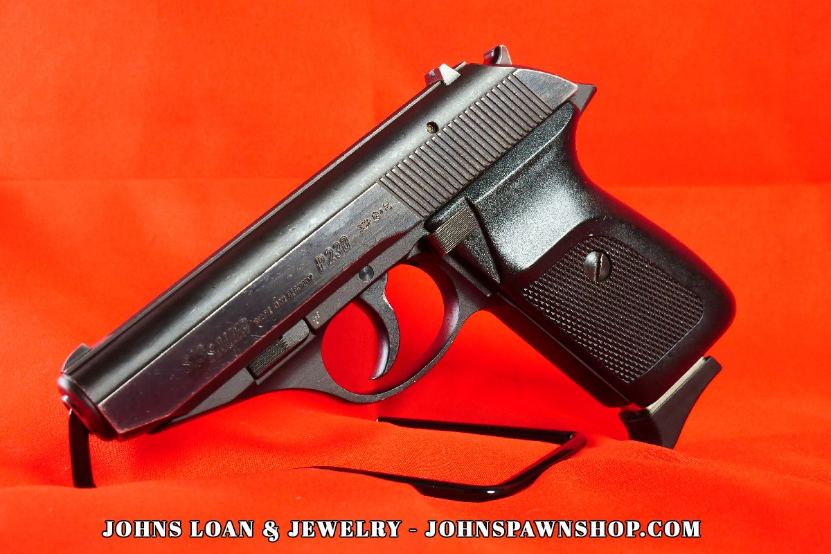 Angled side view of the Sig Sauer P230 .380 ACP pistol, showcasing its compact design, available at John's Loan & Jewelry for concealed carry and home defense.