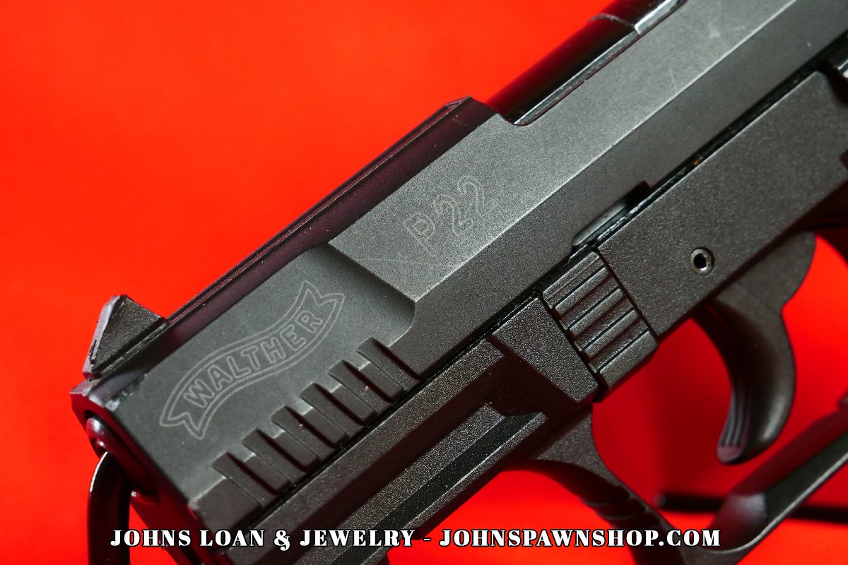 Close-up image of the Walther P22 pistol slide, showcasing the Walther logo and P22 CA engraving; available at John's Loan & Jewelry for firearm enthusiasts and semi-auto pistol collectors.