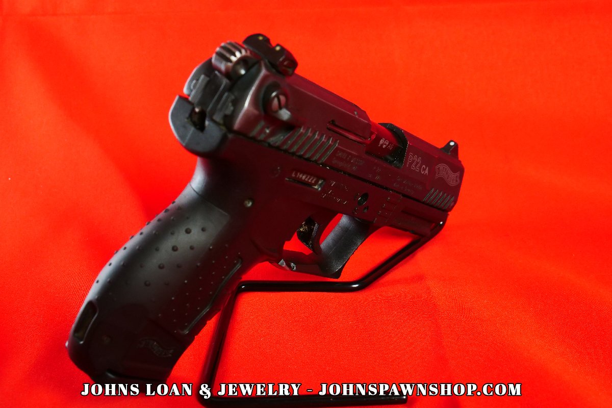 Angled view of the Walther P22 semi-automatic pistol; its polymer frame and textured grip are visible, presented by John's Loan & Jewelry for testing and recreational shooting information.