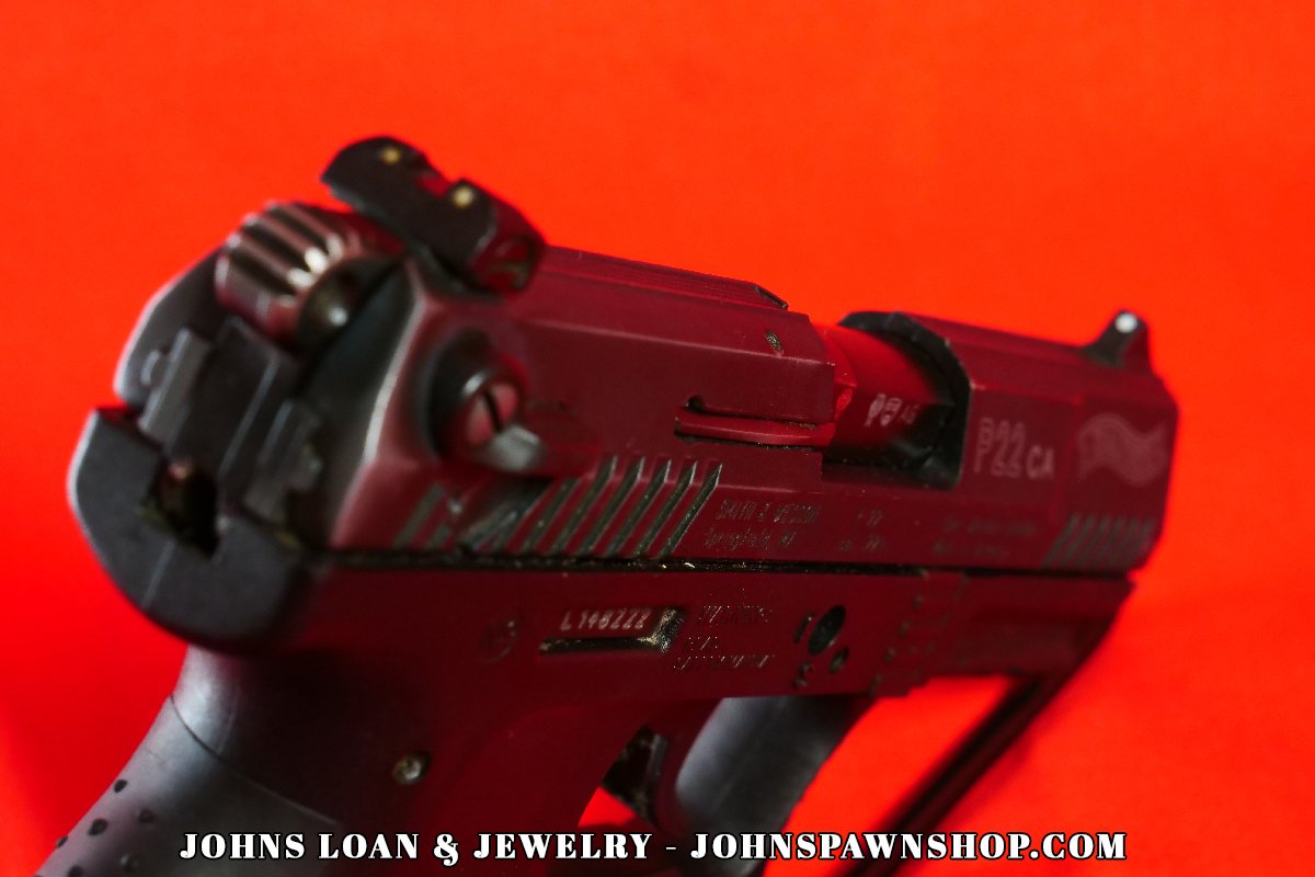 Rear view of the Walther P22 pistol, displaying the adjustable rear sight and slide details; a quality firearm offered by John's Loan & Jewelry for home defense simulation and varmint control.