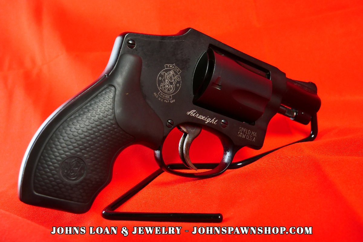 Close-up of the Smith & Wesson 442-1 J Frame .38 Special revolver, showcasing the textured black grip, compact frame, and iconic Smith & Wesson emblem, a firearm offered by John's Loan & Jewelry.
