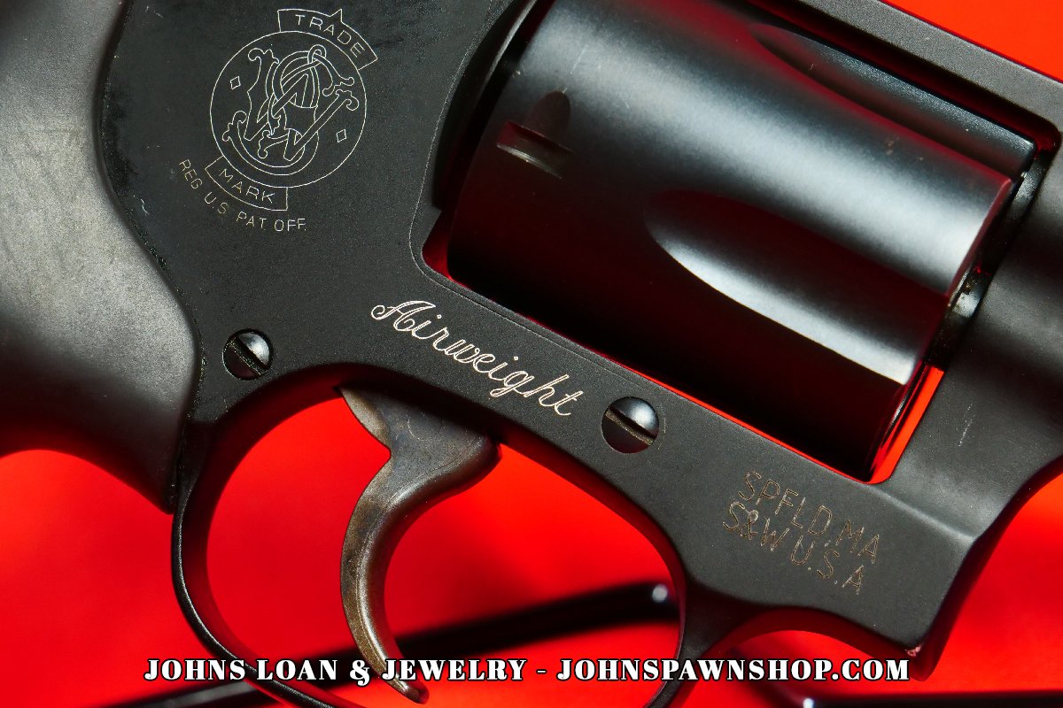 Extreme close-up of the Smith & Wesson 442-1 J Frame revolver, highlighting the 'Airweight' marking, trigger, and .38 Special caliber, offered at John's Loan & Jewelry in Las Vegas.