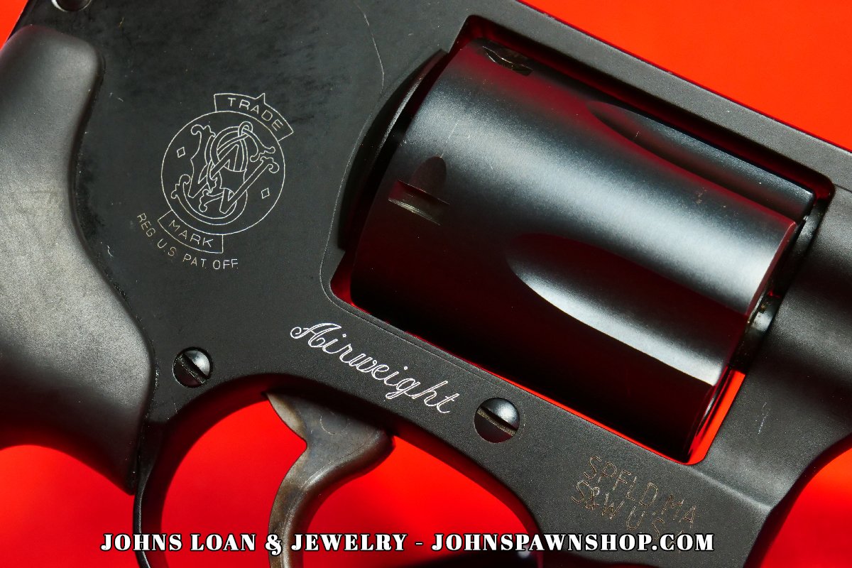 Detailed view of the Smith & Wesson 442-1 J Frame revolver's frame, showing the 'Airweight' inscription, logo, and .38 Special caliber, available at John's Loan & Jewelry for firearm collectors.