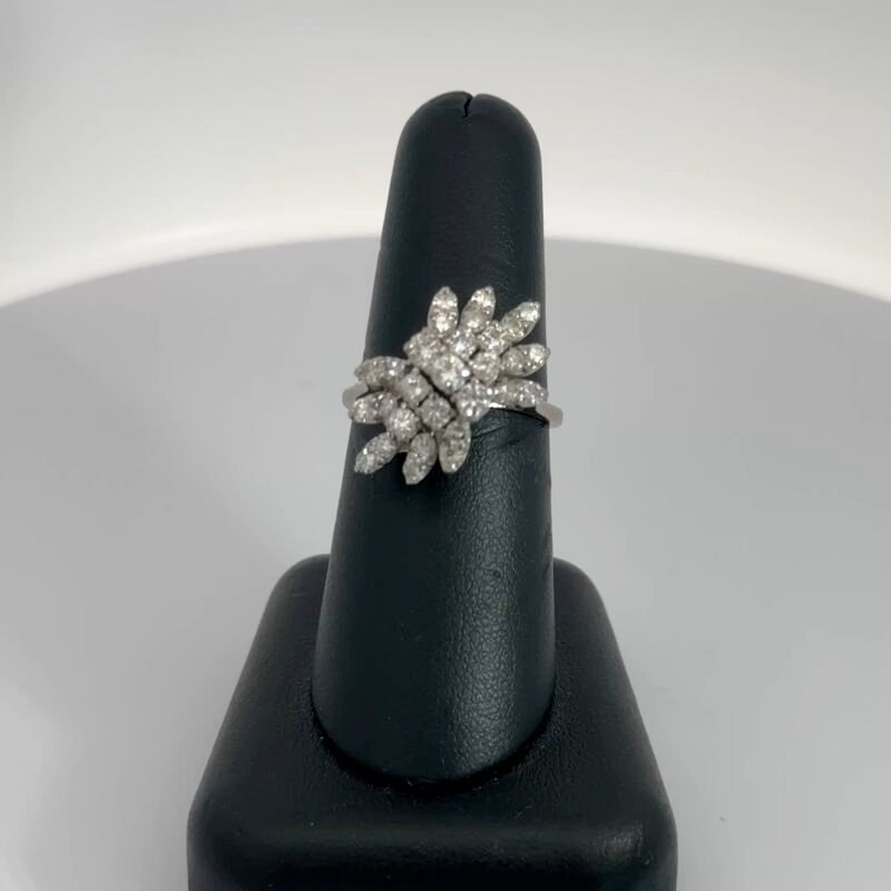 Close-up of John's Loan & Jewelry 14k white gold ladies ring, featuring a natural diamond cluster. The diamonds are arranged in a floral spray design, totaling 1.5ct TW.