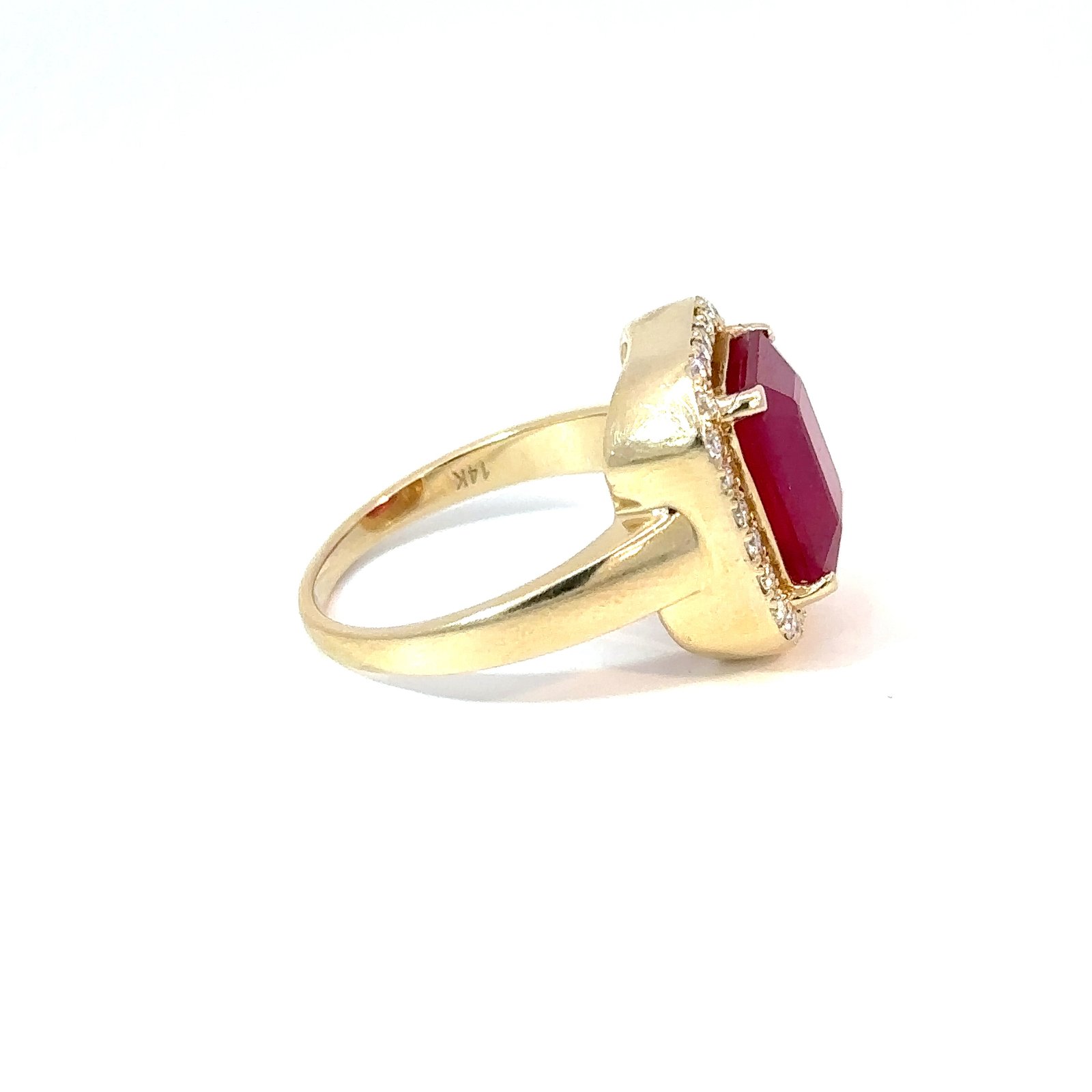Side-profile view of John's Loan & Jewelry 14k yellow gold ring showcases the ruby solitaire's depth and diamond accents, highlighting the ring's yellow gold band.