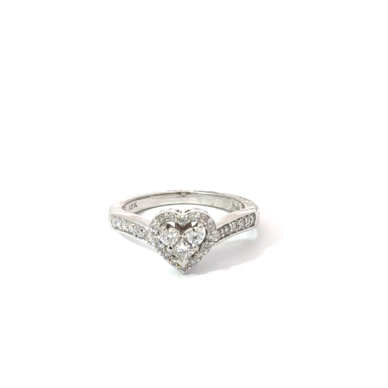 Ladies' 10k white gold ring featuring a 'heart' shaped diamond cluster, available at John's Loan & Jewelry, Las Vegas. Detailed jewelry shot on a white table.