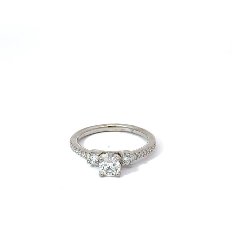 Ladies' white gold engagement ring from John's Loan & Jewelry, featuring a .4ct round center diamond flanked by smaller accent diamonds set in a pavé style along the ring table.