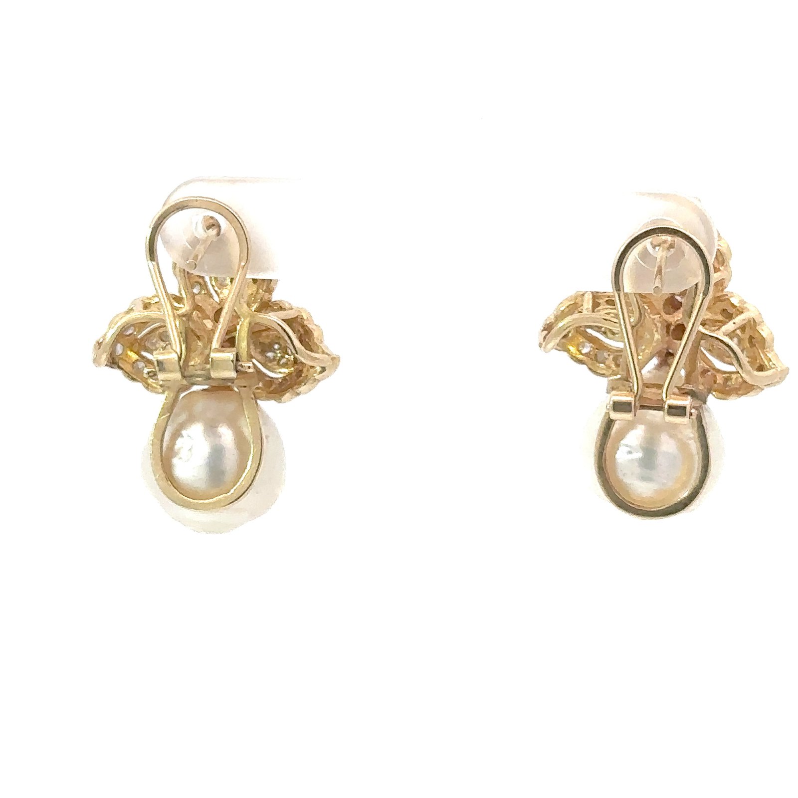 The reverse of a pair of 14k yellow gold and diamond earrings, from John's Loan & Jewelry, with white pearl accents and lever-back closures.
