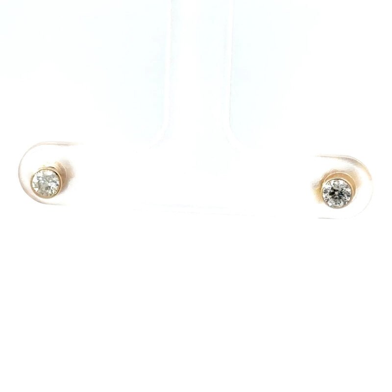 Close-up of John's Loan & Jewelry 14kt yellow gold barrel-set studs. This jewelry image shows diamond earrings with a polished gold table setting, a classic stud design.
