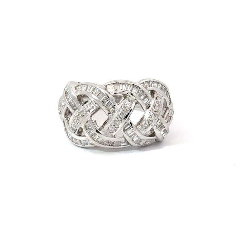 Close-up view of a ladies' 'woven' diamond ring from John's Loan & Jewelry, featuring baguette and round cut diamonds set in a polished 14k white gold band on a white table.