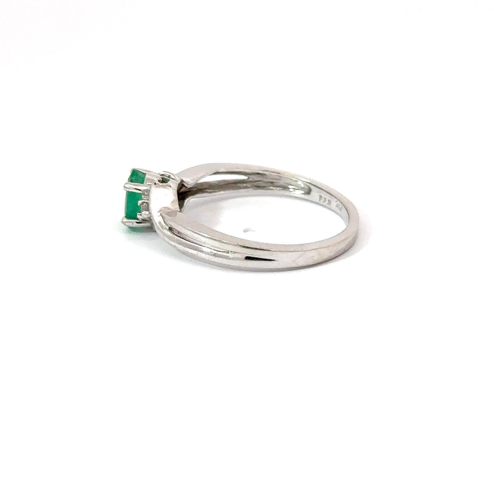 Side profile of John's Loan & Jewelry 14k white gold ring featuring a 0.3ct emerald solitaire; view showcases the band's sleek design and gemstone setting.