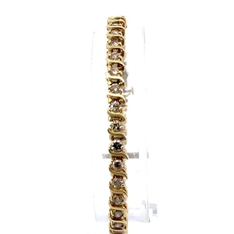 Close-up of a 14k yellow gold tennis bracelet, showcasing the 4ct diamonds, available at John's Loan & Jewelry, a Las Vegas pawn shop specializing in fine jewelry.