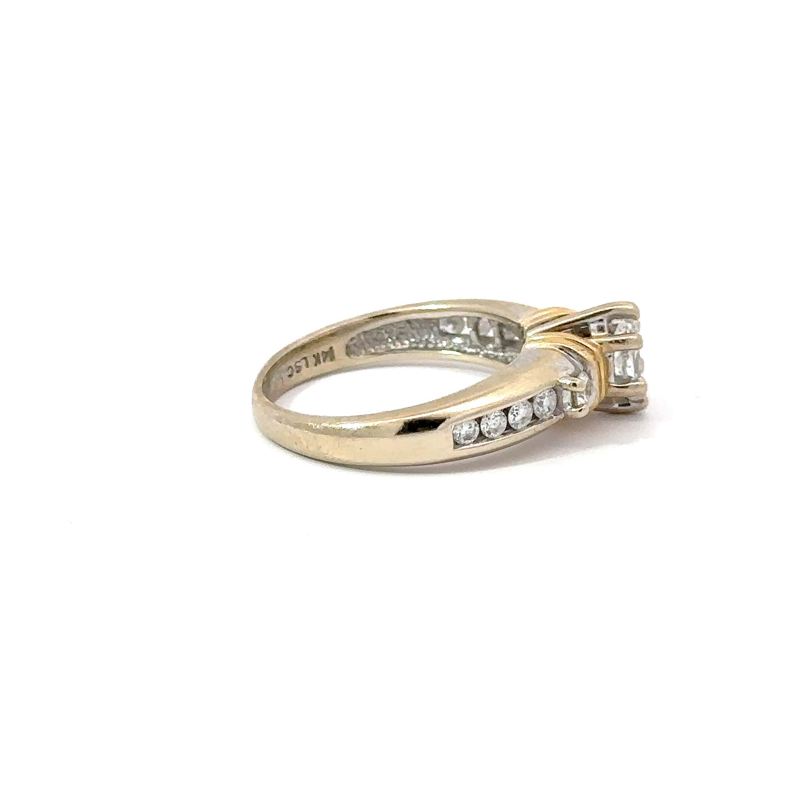 Angled side view of John's Loan & Jewelry 14kt gold ring, displaying the marquise diamond engagement jewelry's setting, channel-set diamonds, and the band's curvature.